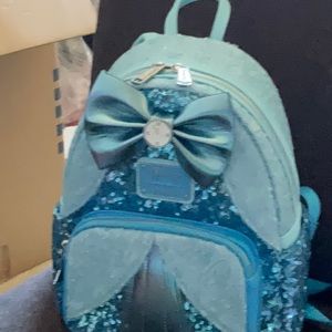 Cinderella sequin loungefly comes with one tag missing some others